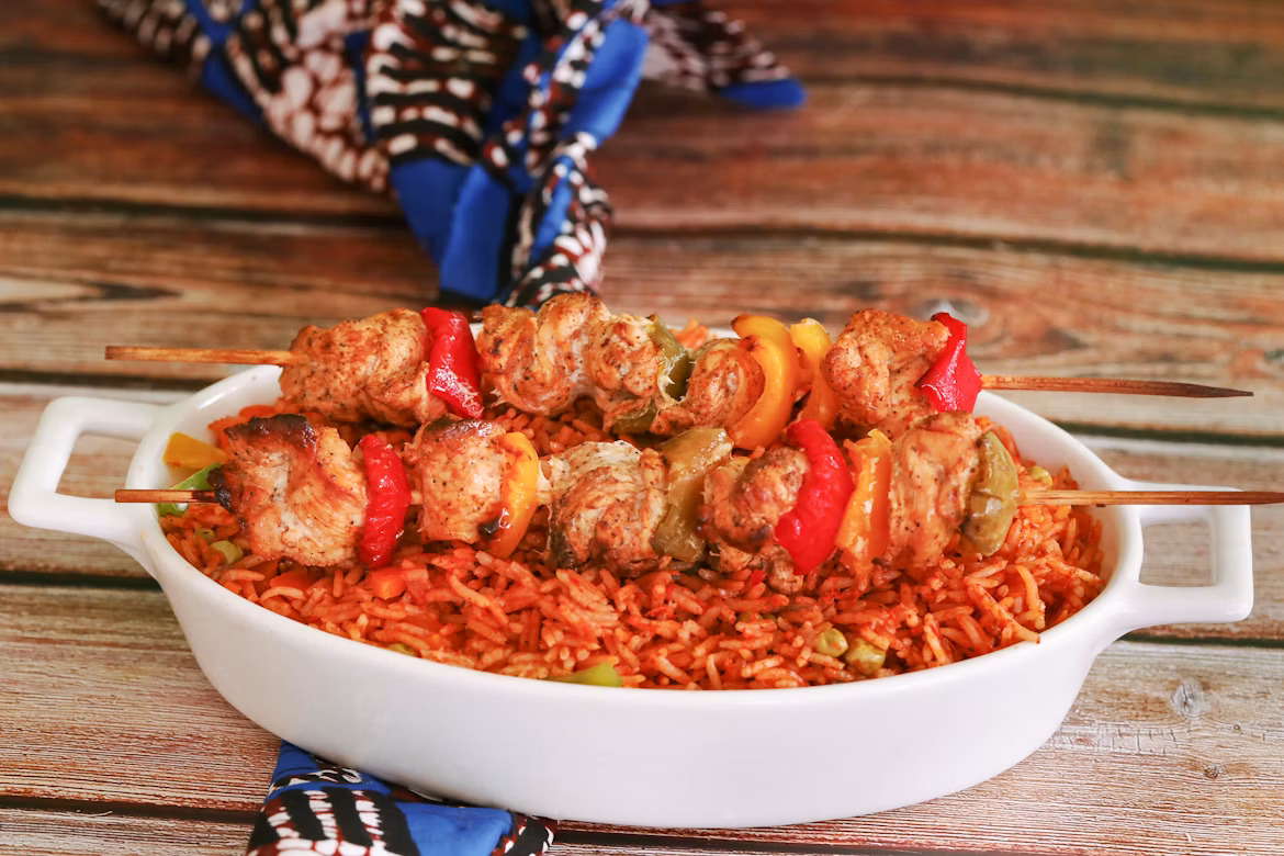 Chicken skewers over jollof rice